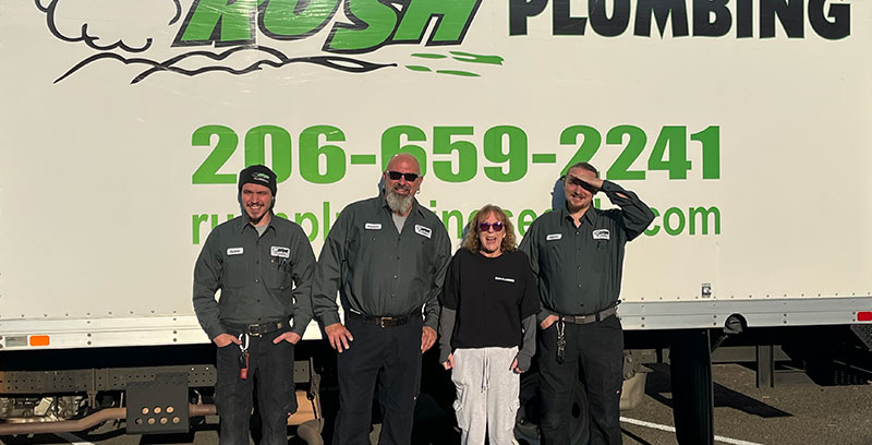 4 Rush Plumbers standing in front of a Rush Plumbing truck before leaving for a Auburn plumbing service
